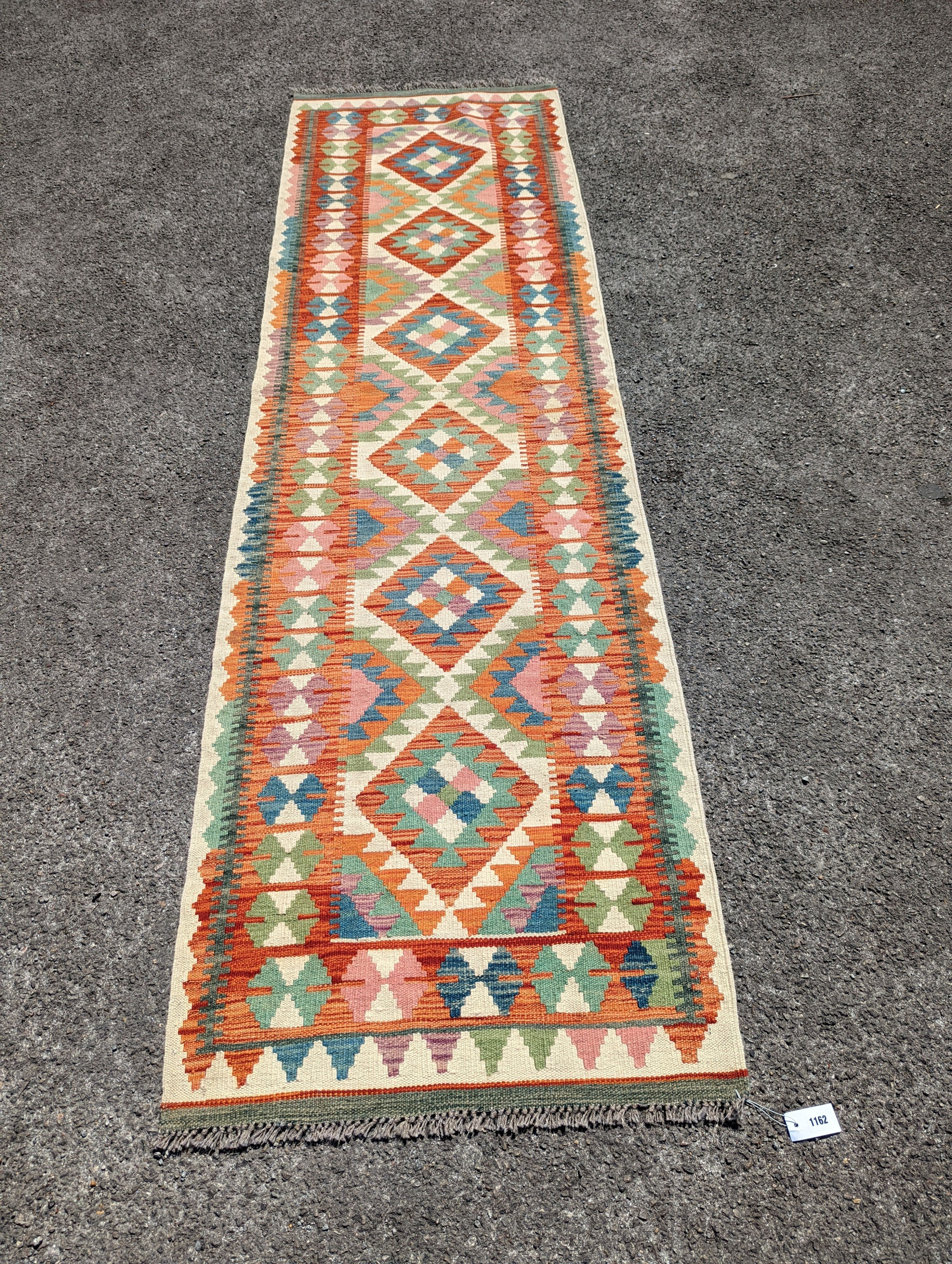 An Anatolian polychrome geometric flatweave Kilim runner, 290 x 84cm